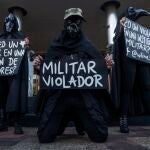 29 June 2020, Colombia, Bogota: Demonstrators hold placards during a demonstration outside the main military unit of Bogota against a reported rape of a young Embera Chami indigenous girl by 7 soldiers. Photo: Daniel Garzon Herazo/ZUMA Wire/dpa29/06/2020 ONLY FOR USE IN SPAIN