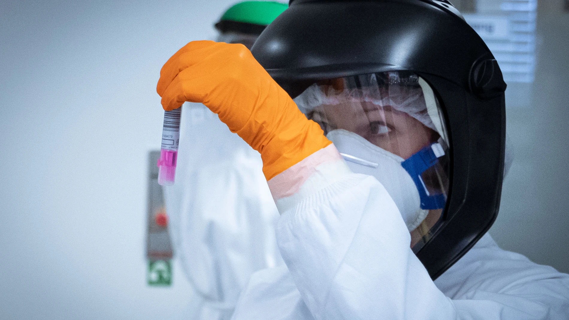 La trabajadora de un laboratorio examina una muestra de un paciente infectado con coronavirus