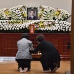 Dos mujeres lloran al fallecido alcalde Park Won Soon en un altar con su fotografía colocado en un hospital de Seúl
