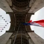 Cazas franceses dibujan la bandera tricolor al sobrevolar el Arco del Triunfo durante la Fiesta del 14 de Julio