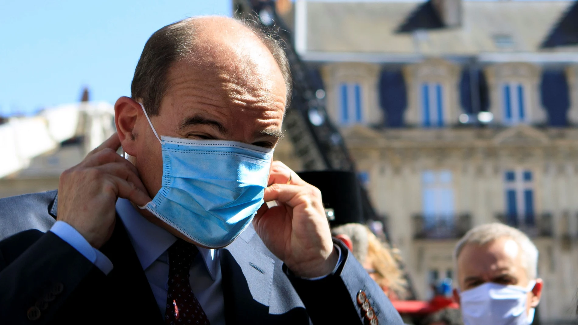 French Prime Minister Jean Castex adjusts his protective mask before taking to the media, after the blaze at the Cathedral of Saint Pierre and Saint Paul in Nantes