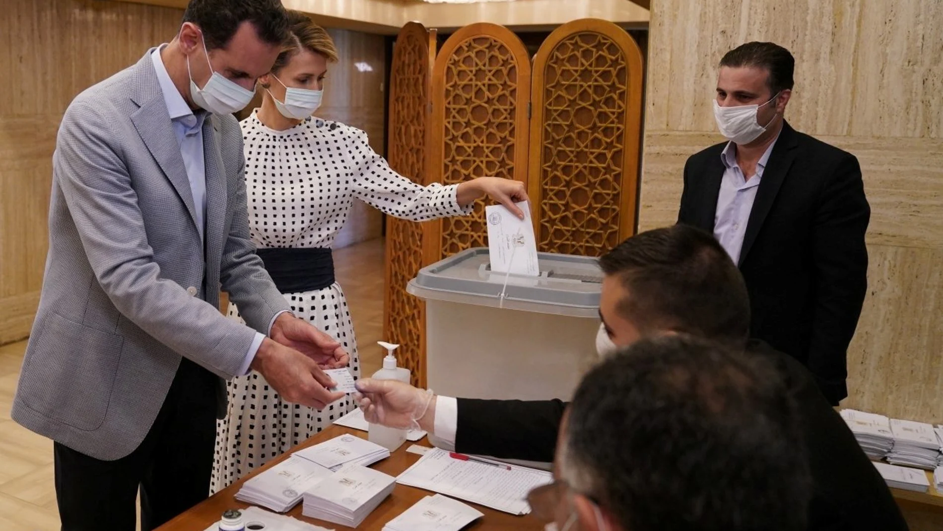 Syria's President Bashar al-Assad and his wife Asma cast their vote inside a polling station during the parliamentary elections in Damascus