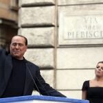 RNPS - PICTURES OF THE YEAR 2013 - Former Italian Prime Minister Silvio Berlusconi waves to supporters as his girlfriend Francesca Pascale looks on during a rally to protest his tax fraud conviction, outside his palace in central Rome August 4, 2013. Tensions in Italy's squabbling coalition heightened ahead of a rally by supporters of Berlusconi in Rome in protest at a tax fraud conviction that threatens his future in politics and the fragile government. REUTERS/Alessandro Bianchi (ITALY - Tags: POLITICS CIVIL UNREST TPX)