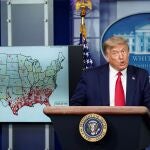 FILE PHOTO: U.S. President Donald Trump stands next to a U.S. map of reported coronavirus cases as he speaks about the administration's plan for reopening schools during a coronavirus (COVID-19) news briefing at the White House in Washington, U.S., July 23, 2020. REUTERS/Kevin Lamarque/File Photo
