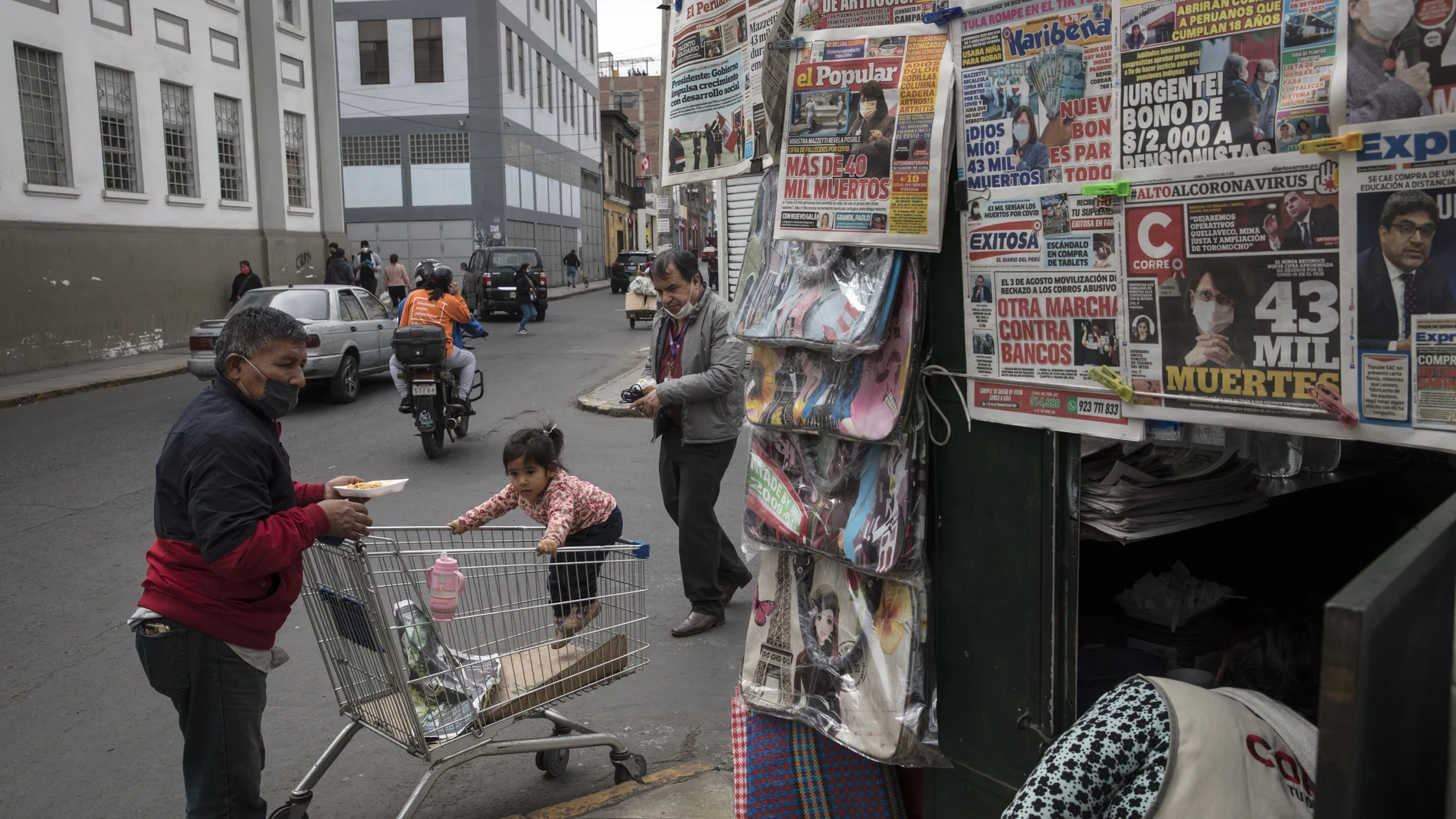 A man wearing a mask to curb the spread of the new coronavirus prepares to eat breakfast on a street in downtown Lima, Peru, Thursday, July 30, 2020. (AP Photo/Rodrigo Abd)