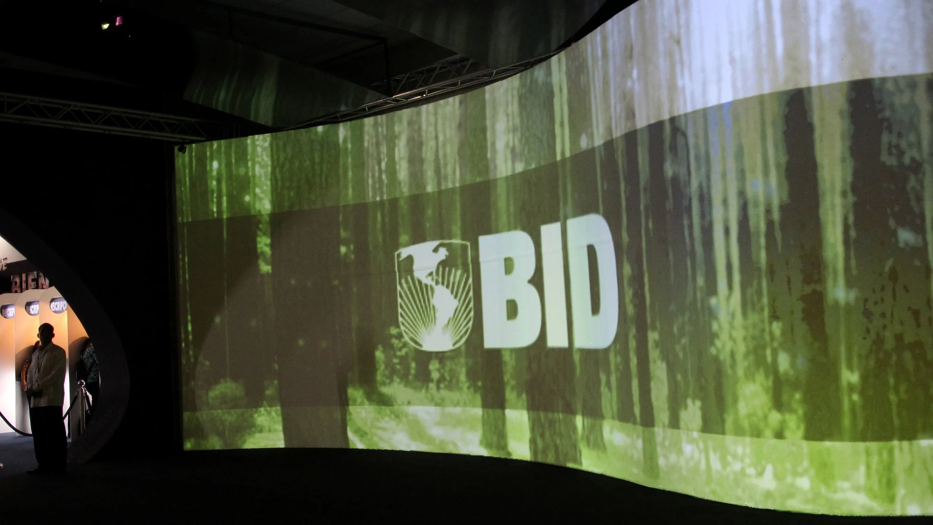 FILE PHOTO: A man stands next to a screen with the logo of Banco Interamericano de Desarrollo (BID) at the Atlapa Convention Center in Panama City