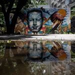AME9572. CARACAS (VENEZUELA), 21/08/2020.- Vista de un mural del expresidente fallecido Hugo Chávez, este jueves, en Caracas (Venezuela). Hace tan solo un año, el posicionamiento era claro y la defensa a ultranza de Nicolás Maduro o Juan Guaidó entre los venezolanos era radical. Polarización nominal que rozaba un fanatismo que, si bien no ha desaparecido por completo, sí se ha difuminado con el paso del tiempo. Para muchos, urge un cambio drástico, una nueva era sin uno ni otro. EFE/ Rayner Peña