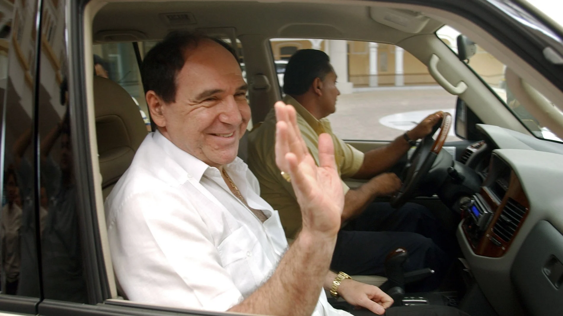 FILE - In this April 27, 2005 file photo, Ecuador's former President Abdala Bucaram waves as he leaves the Foreign Ministery in Panama City, where he sought political asylum after fleeing his country. Bucaram’s lawyer Cristian Romero said on Wednesday, Aug. 26, 2020, that the former president has suffered a heart attack and is interned at a clinic in Guayaquil where he will undergo open heart surgery. (AP Photo/Arnulfo Franco, File)
