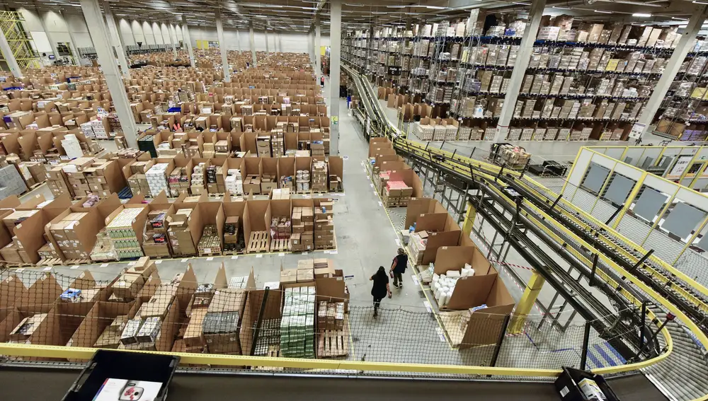 FILE - In this Nov. 14, 2018 file photo, purchase orders leave the giant storehouse of the Amazon Logistic Center in Rheinberg, Germany. Amazon says itâ€™s buying 1,800 electric delivery vans from Mercedes-Benz, the biggest such order for the German automaker to date. Mercedes says it will also join a climate initiative established by Amazonâ€™s founder Jeff Bezos, committing itself to going completely carbon neutral by 2039. (AP Photo/Martin Meissner)