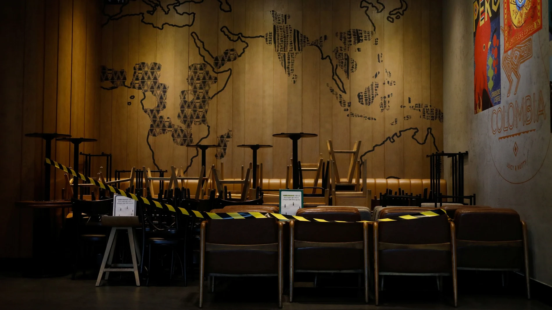 Tables and chairs for customers are stacked in a corner as a measure to avoid the spread of the coronavirus disease (COVID-19) at a Starbucks cafe in Seoul