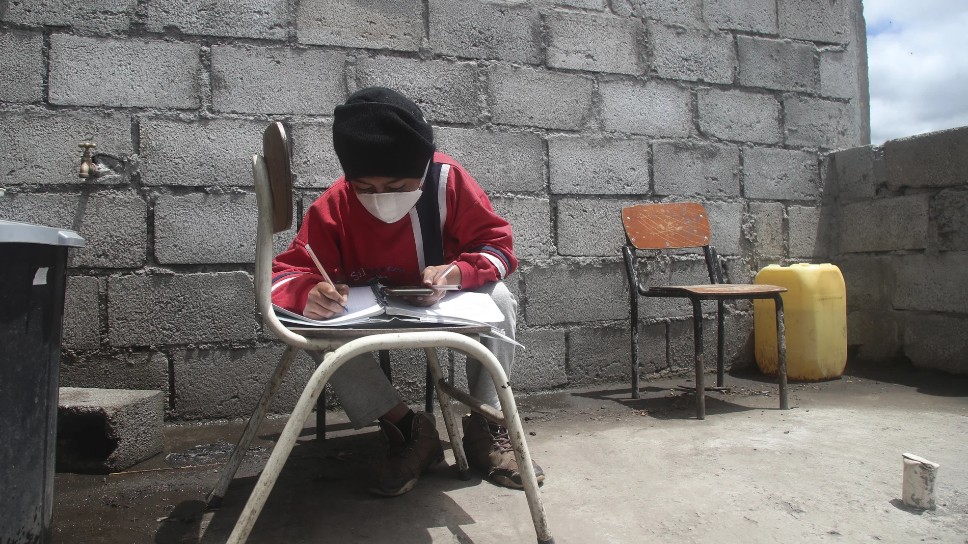 Mateo Ulcuango attends a virtual class using the Zoom app from his home in Cangahua Alto, Ecuador, Thursday, Sept. 3, 2020. Because of the unabated COVID-19 pandemic, Ecuador has started the new school year imparting classes via the internet. (AP Photo/Dolores Ochoa)