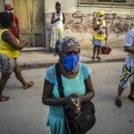 People wearing face masks amid the new coronavirus pandemic pray during a Catholic Mass broadcast by radio in honor of the Virgin of Charity of Cobre, on her feast day in Havana, Cuba, Tuesday, Sept. 8, 2020. The virgin is Cuba's Catholic patron saint. (AP Photo/Ramon Espinosa)