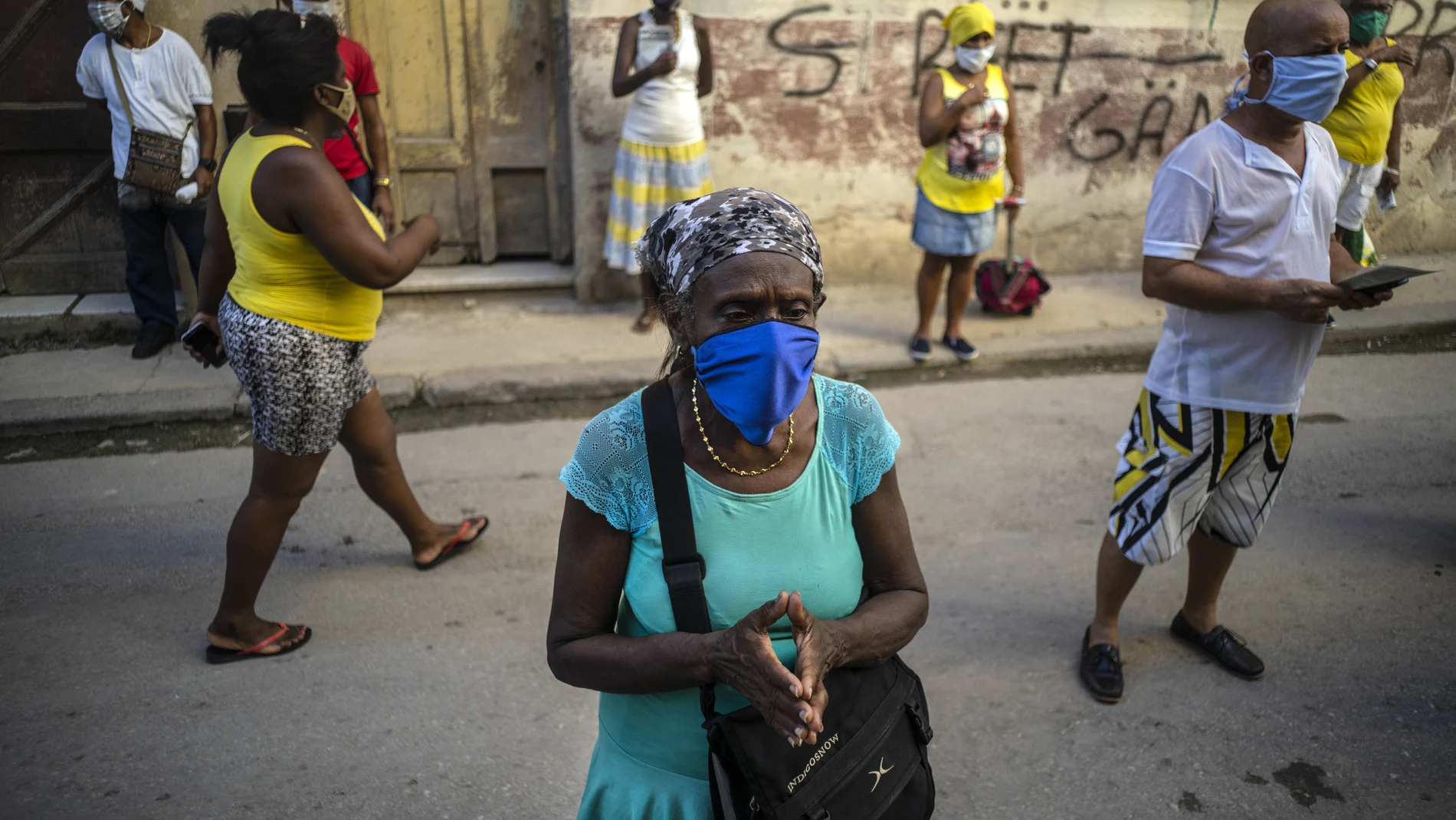 People wearing face masks amid the new coronavirus pandemic pray during a Catholic Mass broadcast by radio in honor of the Virgin of Charity of Cobre, on her feast day in Havana, Cuba, Tuesday, Sept. 8, 2020. The virgin is Cuba's Catholic patron saint. (AP Photo/Ramon Espinosa)