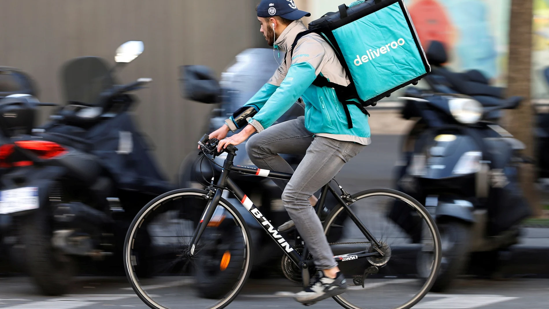 FILE PHOTO: A cyclist rides a bicycle as he delivers a food order for Deliveroo, an example of the emergence of what is known as the 'gig economy', in Paris