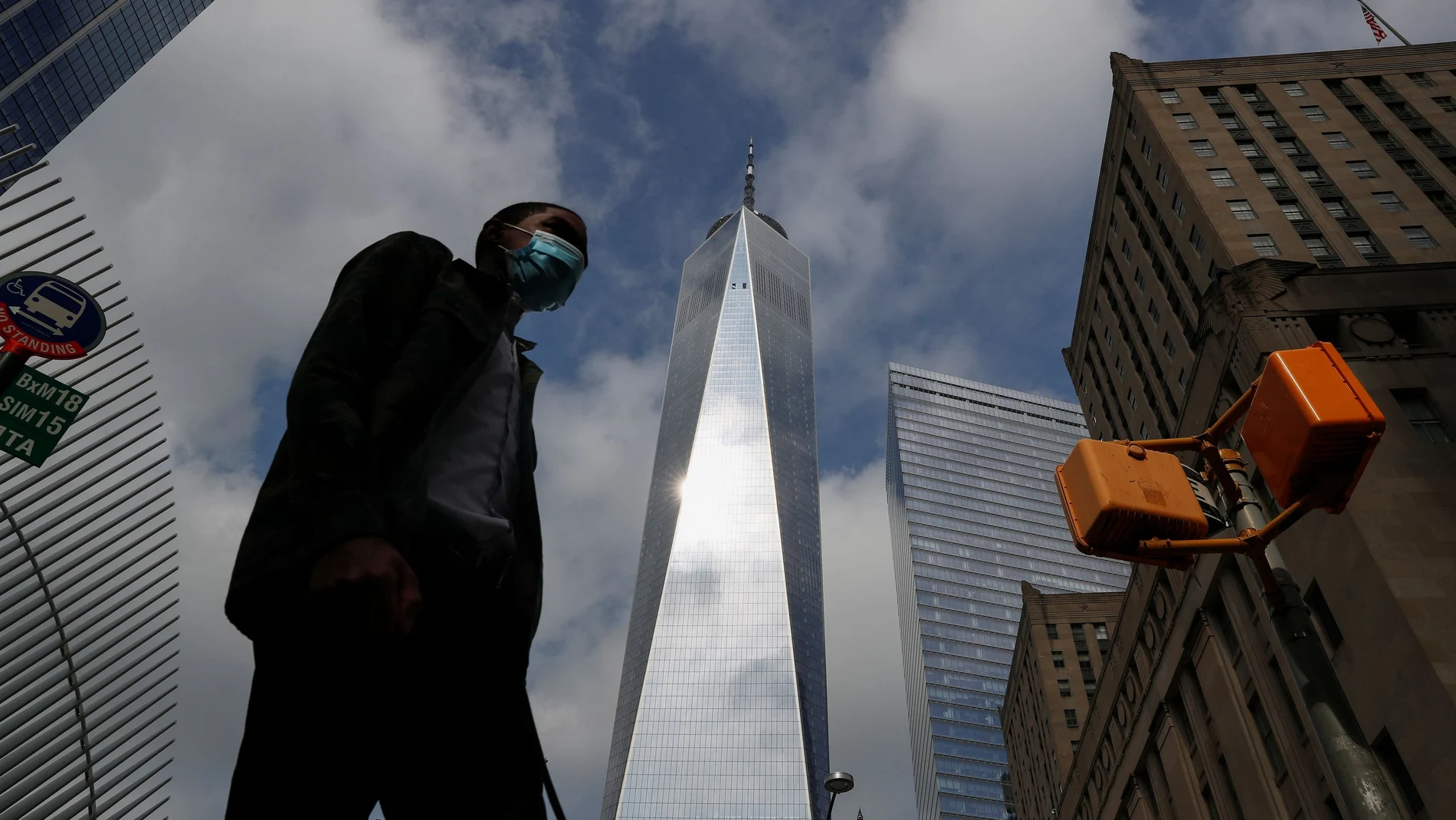 A man wearing a protective face mask walks by One World Trade Center two days before the 19th anniversary of the 9/11 attacks, amid the coronavirus disease (COVID-19) pandemic, in the lower section Manhattan, New York City