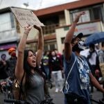 People protest outside a police station after a man, who was detained for violating social distancing rules, died from being repeatedly shocked with a stun gun by officers, according to authorities, in Bogota, Colombia September 10, 2020. The sign reads: "Who takes care of us from the police". REUTERS/Luisa Gonzalez