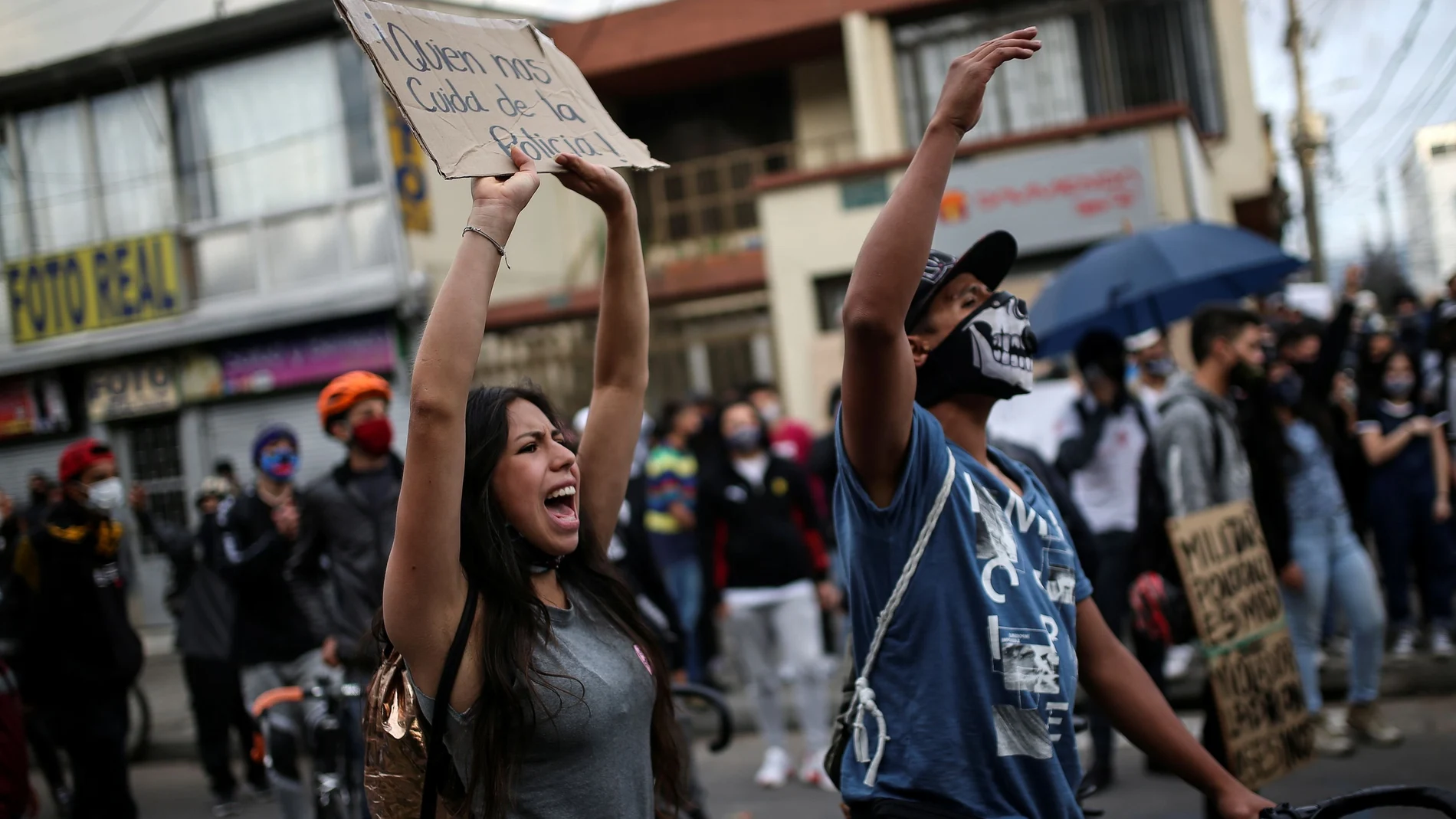 People protest outside a police station after a man, who was detained for violating social distancing rules, died from being repeatedly shocked with a stun gun by officers, according to authorities, in Bogota