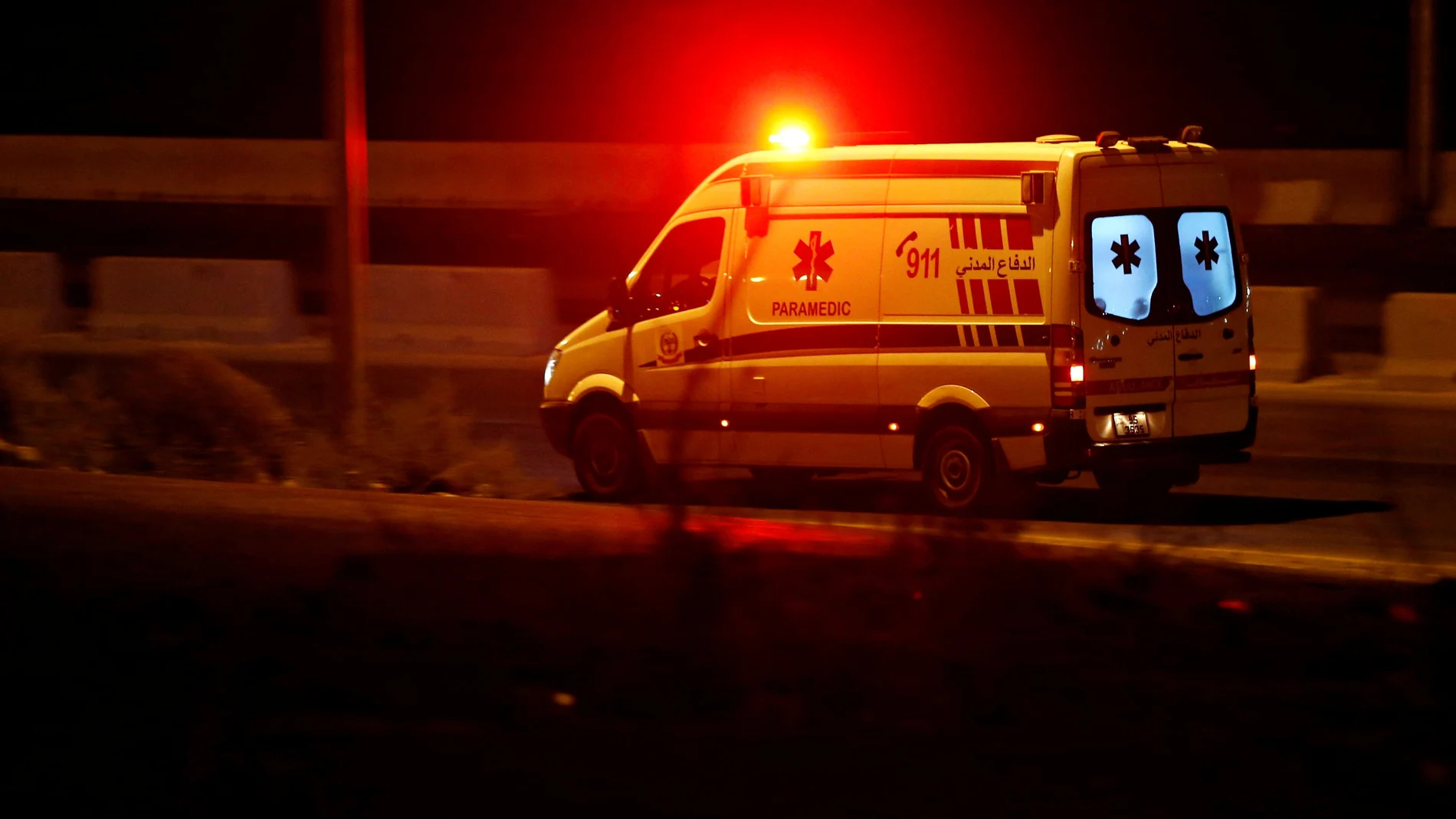 An ambulance heads towards the city of Zarqa on the highway between Amman and Zarqa