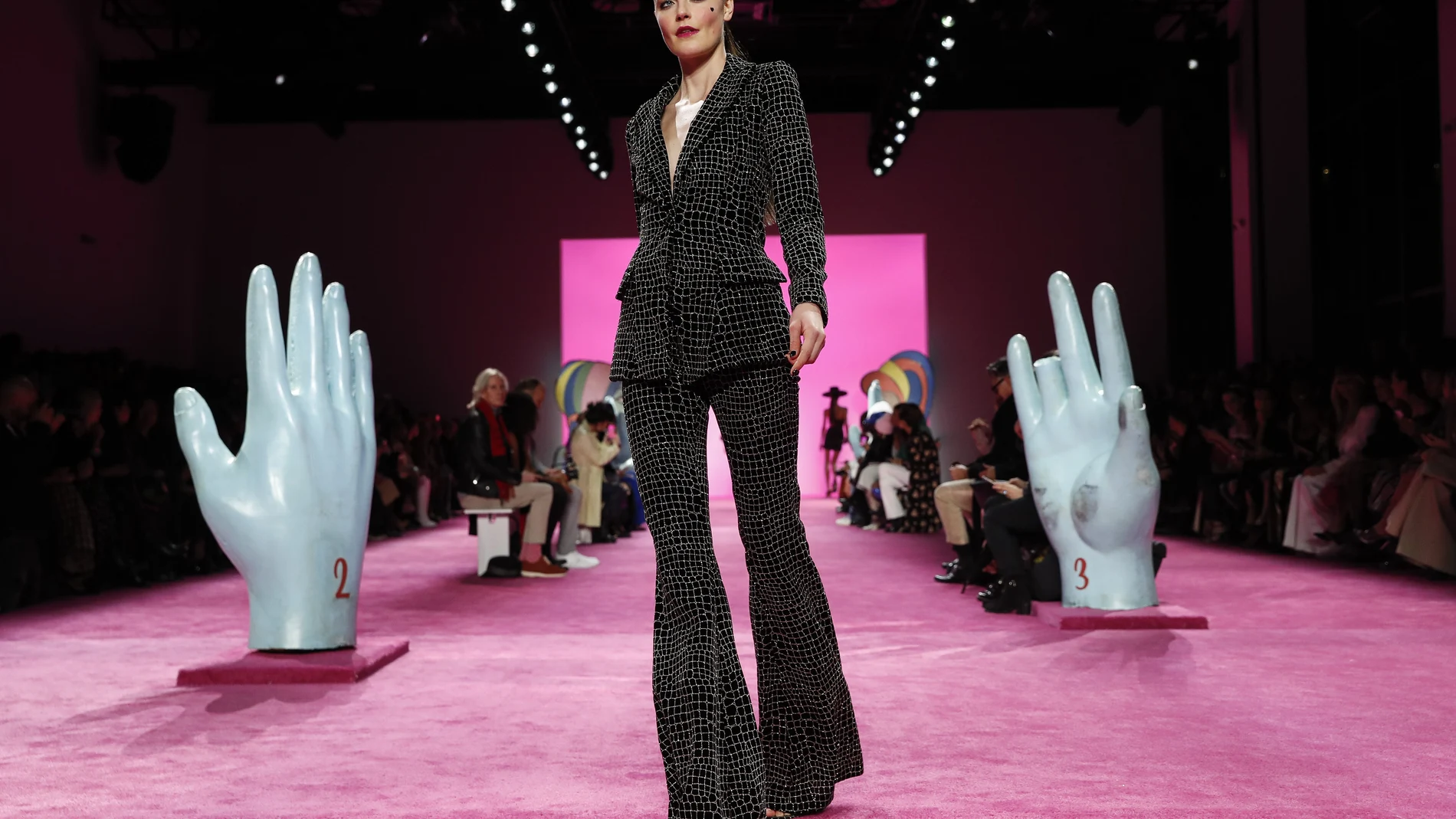 FILE - The Christian Siriano collection is modeled during Fashion Week in New York on Feb. 6, 2020. With no celebs in the front row, no paparazzi chasing models down the streets, no stiletto-heeled crowds and no live shows at all, is there even a point to doing Fashion Week in 2020? Well, yes, say organizers: Itâ€™s about business. And jobs. And survival. (AP Photo/John Minchillo, File)