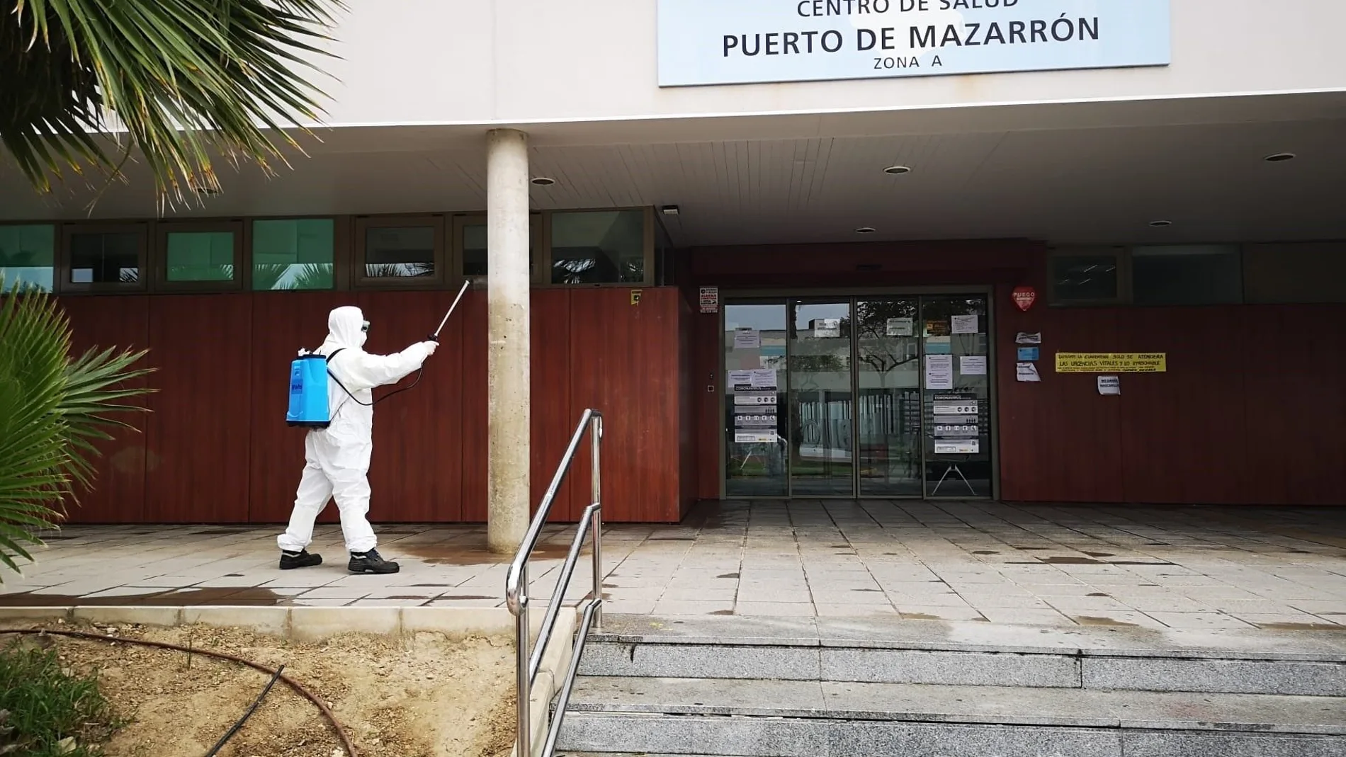Un operario fumiga en la puerta del centro de salud de Mazarrón