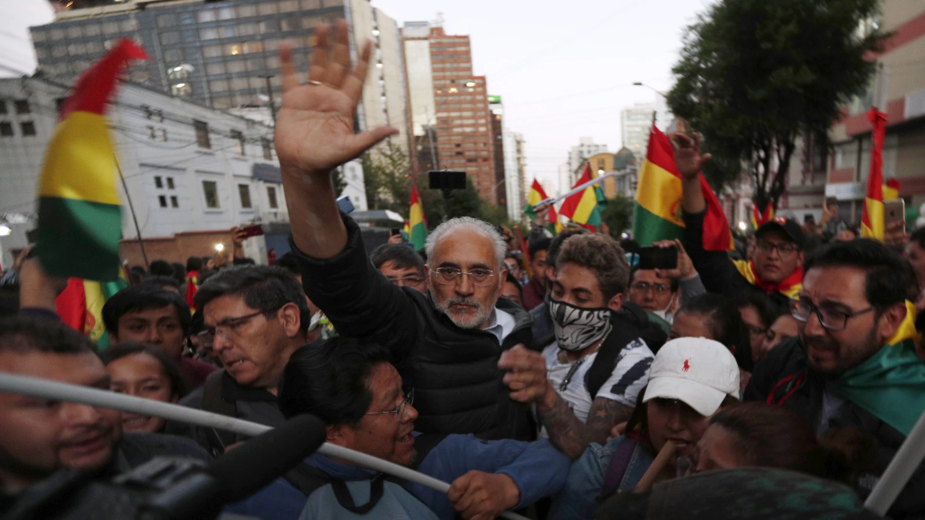 FILE - In this Oct. 22, 2019 file photo, Bolivia's opposition presidential candidate Carlos Mesa waves to supporters during an anti-government march in La Paz, Bolivia. A main candidate, Mesa draws much of his support from Bolivia's urban, more affluent population. (AP Photo/Juan Karita, File)