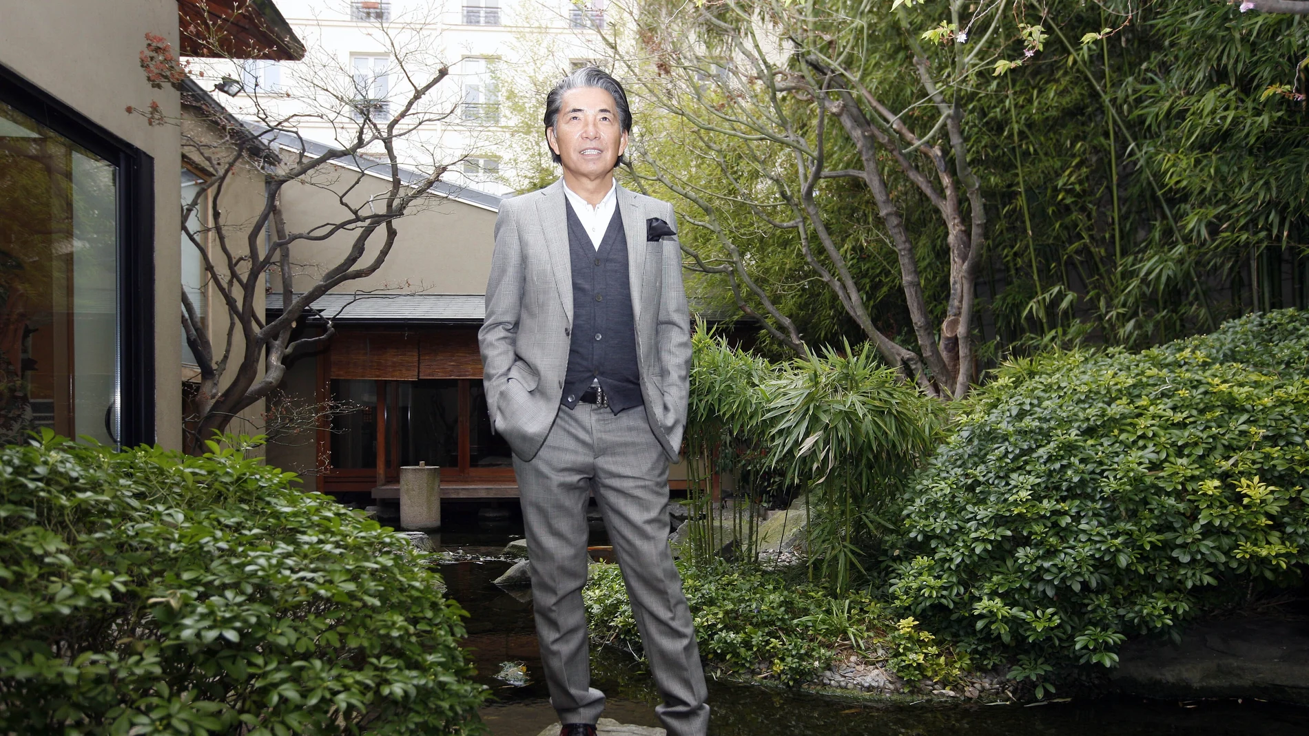 FILE - In this Tuesday, March 24, 2009 file photo, Japanese fashion designer Kenzo Takada poses outside his Paris house. Fashion designer Kenzo Takada dies from COVID-19 complications at age 81 near Paris, spokeswoman and reports said Sunday Oct. 4, 2020. (AP Photo/Jacques Brinon, file)