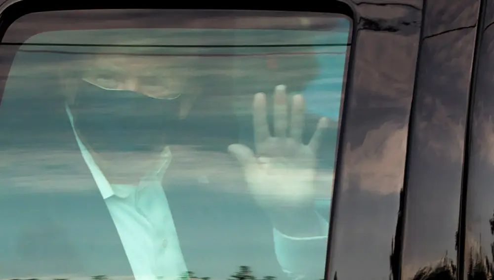 Trump saluda a sus seguidores desde el coche