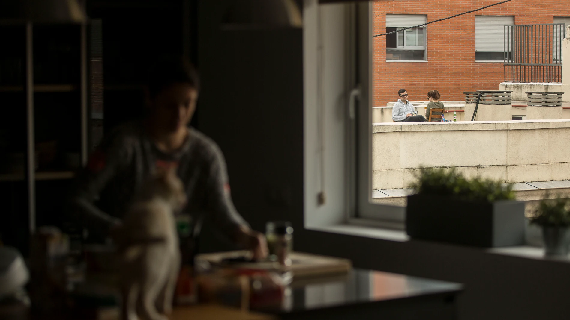 Una pareja toma el aperitivo en la azotea de su edificio durante el estado de alarma por la pandemia del coronavirus.