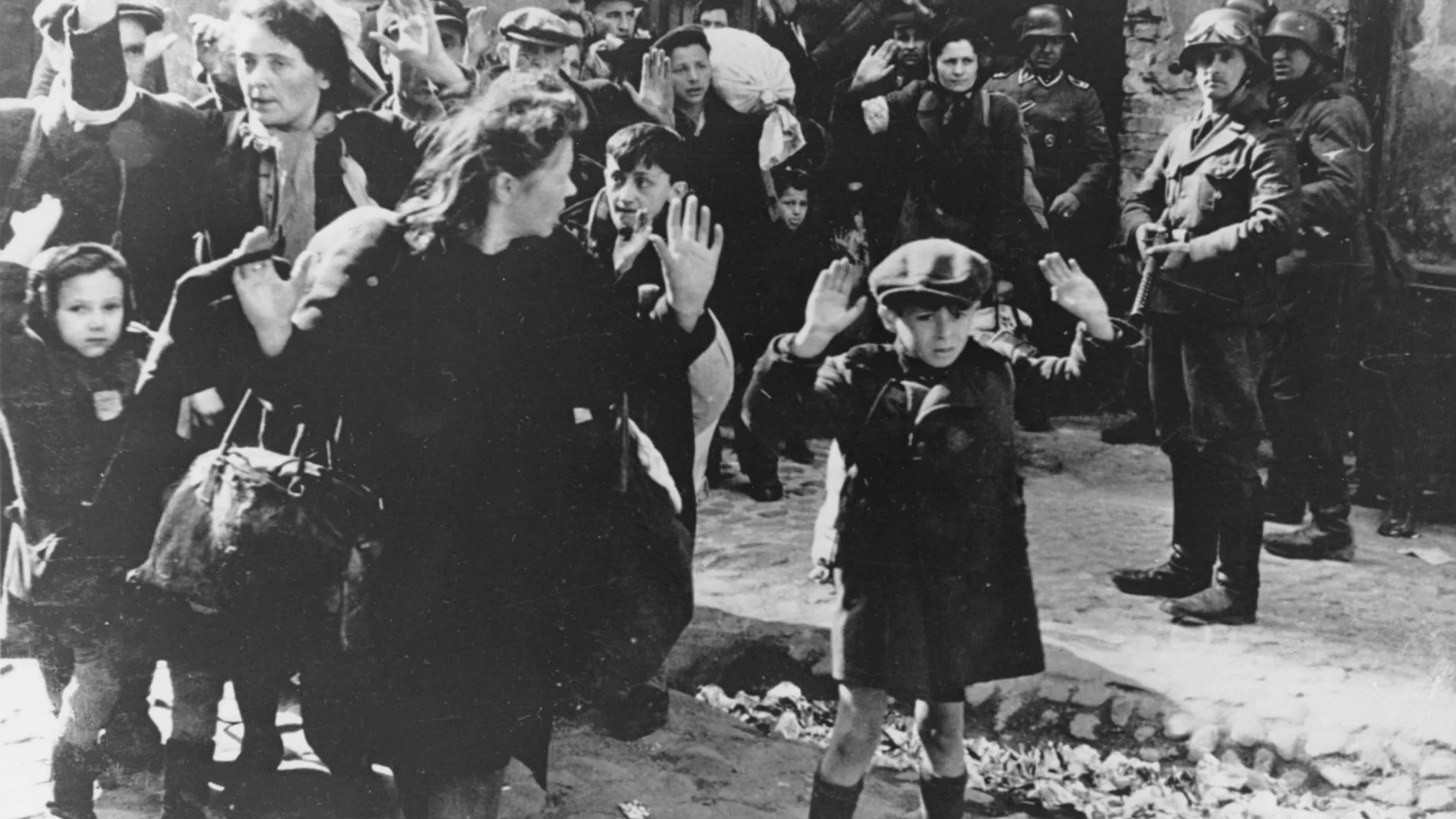 FILE-This Feb. 17, 1941 file photo shows a scene in the Warsaw Ghetto where Jews wearing white armlets bearing the Star of David board a tram marked with the words For Jews Only. After a year of tough negotiations, Germany agreed Monday, Dec. 5, 2011, to pay pensions to about 16,000 Holocaust victims worldwide who survived wartime ghettos or were forced to hide from Nazi persecution. (AP Photo, File)