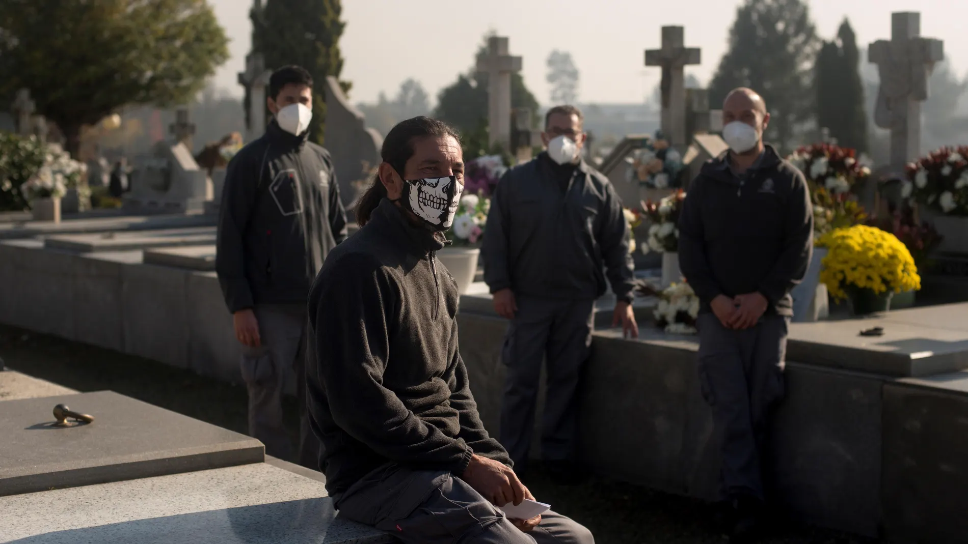 Juan González (Orense, 1973) (izda), un veterano enterrador oficial de cementerios, posa para Efe en el cementerio de Santa Mariña en Orense. González empezó a trabajar de enterrador con 23 años recién cumplidos. Perdió a su madre con 7 años y se preparó a conciencia para el oficio. Prefería un camposanto a una oficina. Lo que nunca imaginó es que fuese a haber aforos ni limitaciones horarias para las visitas, como lo que ocurre en este momento histórico, que afecta especialmente en este puente de Todos Los Santos, por la epidemia de coronavirus. EFE/ Brais Lorenzo