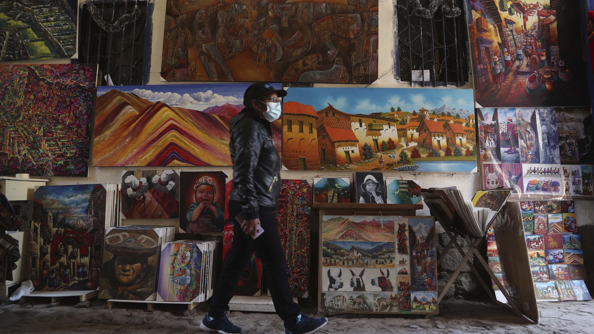 Artist Elizabeth Correa waits for clients to her paints amid the COVID-19 pandemic Cusco, Peru, Monday, Oct. 26, 2020. Cusco, the historic capital of the Inca empire near Machu Picchu lives almost entirely from international tourism and is suffering the worst crisis in its recent history. (AP Photo/Martin Mejia)