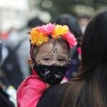 A child wears a face mask as women protest on the Day of the Dead against gender violence and femicide, in Mexico City, Mexico, November 2, 2020. REUTERS/Raquel Cunha
