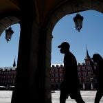 Dos turistas visitan la Plaza Mayor de Madrid.