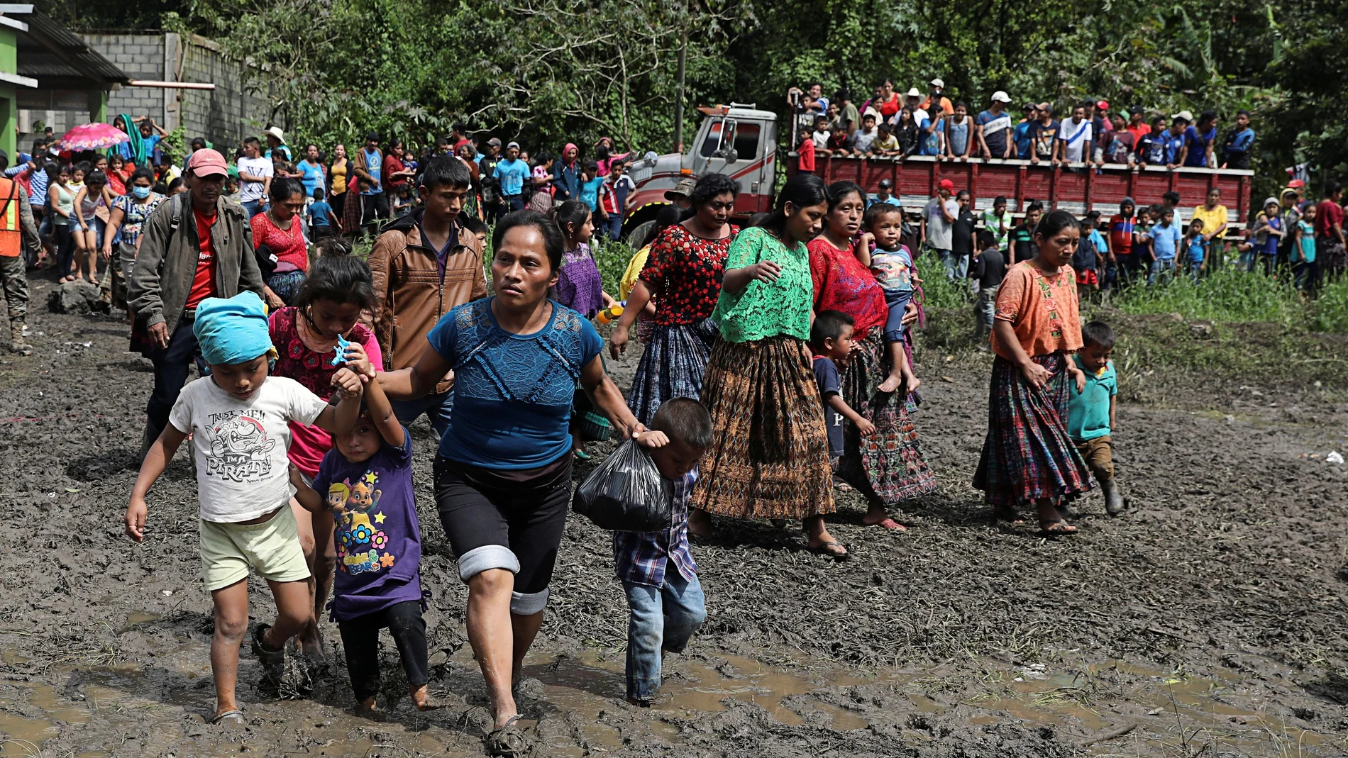People walk at a school area that is being used as a temporary shelter for residents of neighbouring villages affected by the mudslides, due to heavy rains brought by Storm Eta, in the village of Santa Elena, Alta Verapaz, Guatemala November 8, 2020. Picture taken November 8, 2020. REUTERS/Luis Echeverria