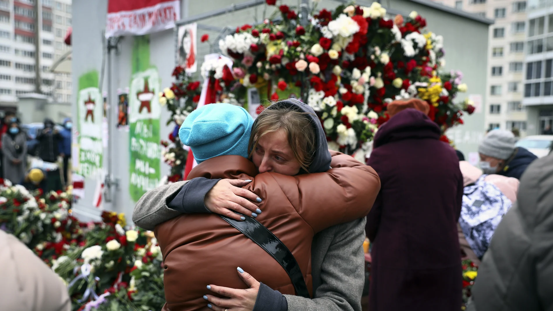 Dos mujeres se abrazan en un memorial por Raman Bandarenka en Minsk.