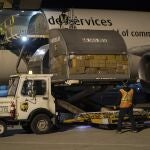 In this photo provided by Canada's Department of National Defence, shipments of initial doses of COVID-19 vaccines are unloaded, late Sunday, Dec. 13, 2020, in Canada. Officials would not disclose the airport or city. (Cpl. Matthew Tower/Canada's Department of National Defence via AP)