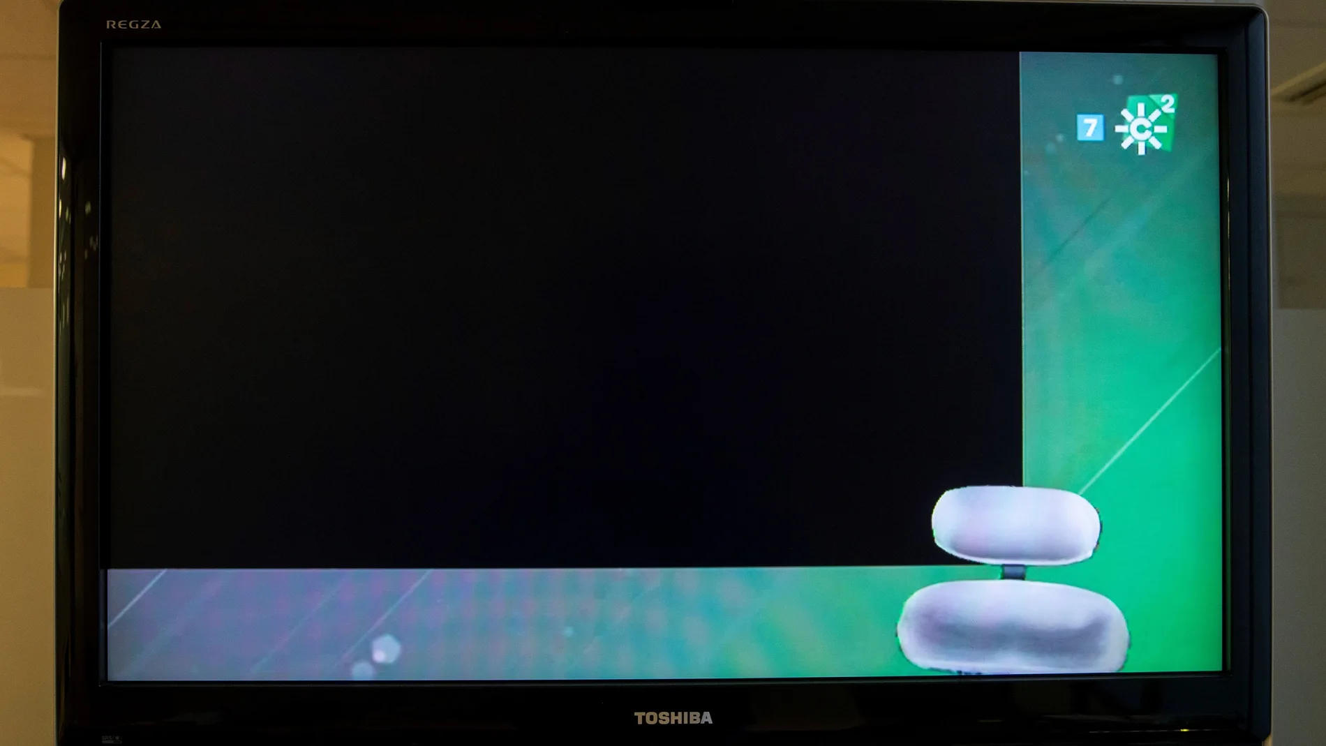 Una pantalla de un televisor encendido muestra la emisión del segundo canal de Canal Sur en negro y con la silla del intérprete de la lengua de signos vacía