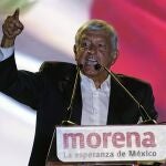 FILE - In this June 27, 2018 file photo, then presidential candidate Andres Manuel Lopez Obrador, of the MORENA party, holds his closing campaign rally at Azteca stadium in Mexico City. Mexico's three main opposition parties have announced on Tuesday, Dec. 22, 2020, an odd alliance to try to wrest control of the lower house of congress from President Andres Manuel Lopez Obrador's Morena party in elections set for June 6. (AP Photo/Ramon Espinosa, File)