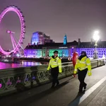 London (United Kingdom), 31/12/2020.- Police officers walk along Westminster Bridge in front of the London Eye, in London, Britain, 31 December 2020. New Year's Eve celebrations are not taking place in London due to coronavirus restrictions. The UK government is encouraging people to stay home as Covid-19 cases continue to surge. (Reino Unido, Londres) EFE/EPA/ANDY RAIN
