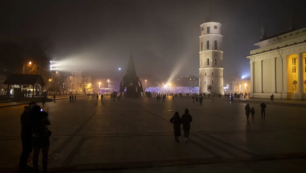 A view of an empty Cathedral Square shortly after midnight during the New Year's celebrations in Vilnius, Lithuania, Friday, Jan. 1, 2021. Due to the current corona restrictions the annual New Year's Eve celebrations at the Cathedral Square with hundreds of thousands guests won't take place this year. Lithuania is entering 2021 in a lockdown that appears certain to be extended beyond its current Jan. 31 end date, with new coronavirus cases and deaths related to COVID-19 remaining at worryingly high levels. The area around the Cathedral Square is the main place for New Year's celebration in the Lithuanian capital but because of the COVID-19 pandemic all public celebrations are banned. (AP Photo/Mindaugas Kulbis)