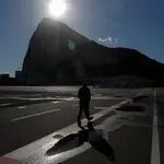 A man crosses the tarmac of the Gibraltar International Airport near the border between Gibraltar and Spain, following a post-Brexit deal, in Gibraltar, January 1, 2021. REUTERS/Jon Nazca
