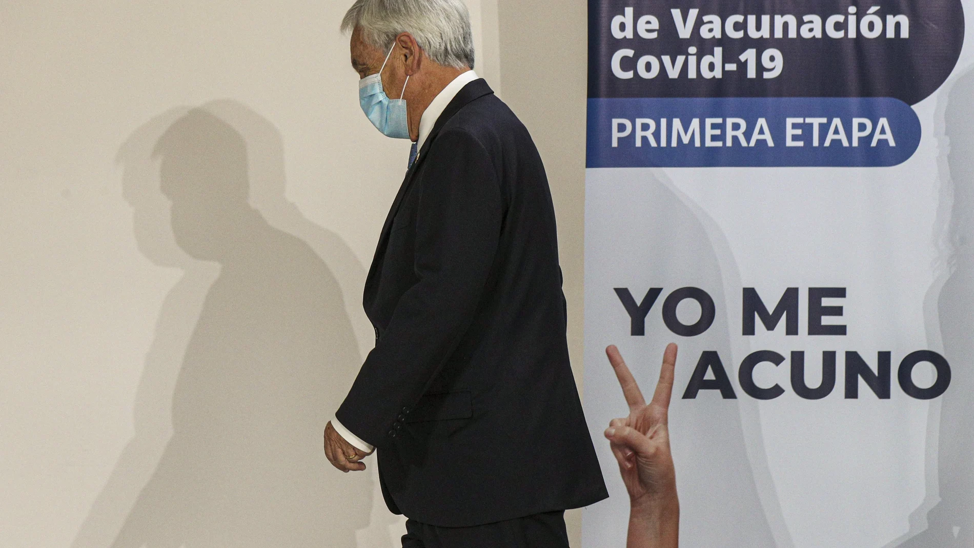 FILE - In this Dec. 24, 2020, file photo, Chilean President Sebastian Pinera walks away after observing the first vaccination shots for COVID-19 at the Metropolitan Hospital in Santiago, Chile. World leaders, including Pinera, are condemning the storming of the U.S. Capitol by supporters of President Donald Trump. (AP Photo/Esteban Felix, File)