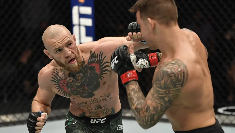 Jan 23, 2021; Abu Dhabi, United Arab Emirates; Conor McGregor of Ireland punches Dustin Poirier in a lightweight fight during the UFC 257 event inside Etihad Arena on UFC Fight Island. Mandatory Credit: Jeff Bottari/Handout Photo via USA TODAY Sports