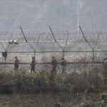 Soldados del ejército surcoreano patrullan a lo largo de la cerca de alambre de púas en Paju, Corea del Sur, cerca de la frontera con Corea del Norte