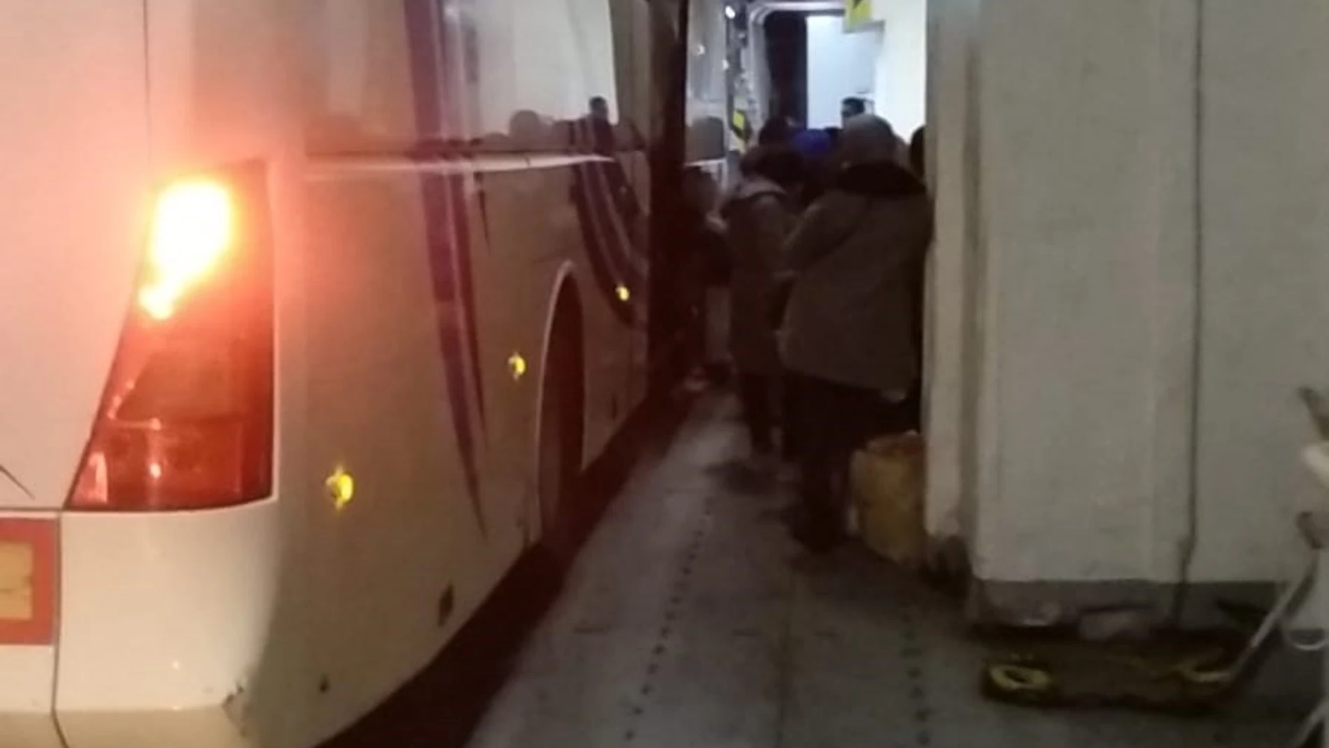 Temporeras accediendo a los autobuses de las asociaciones agrícolas para trasladaslas a Huelva desde el Puerto de Algeciras