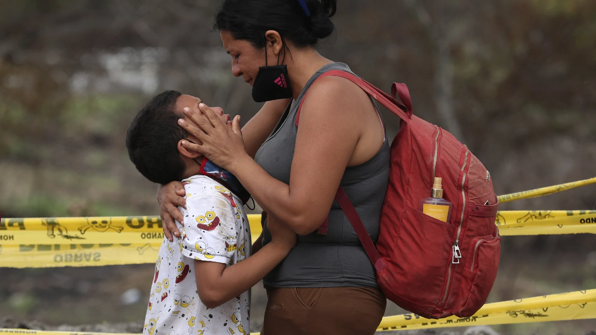 Venezuelan migrant Edi Briceno comforts her son Erick at a checkpoint before they are returned to Ecuador, in Tumbes, Peru, Friday, Jan. 29, 2021. Peru has sent soldiers to patrol the porous border to stop the illegal influx of Venezuelan migrants. While Peru doesn’t share a border with Venezuela, many migrants try to reach it by going through Ecuador or Colombia. (AP Photo/Martin Mejia)