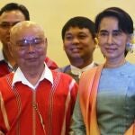 FILE - In this Aug. 24, 2016, file photo, then Myanmar's Foreign Minister Aung San Suu Kyi, right, and Mutu Say Po, chairman of Karen National Union (KNU) pose for photos during their meeting at a hotel in Naypyitaw, Myanmar days before a peace conference that seeks to end decades of armed conflict with ethnic minority groups. The future of the Myanmarâ€™s already-fragile peace process between the military, ethnic armed groups and militias is in question as the military regains control of the country after Feb. 1, 2021 coup. (AP Photo/Aung Shine Oo, File)