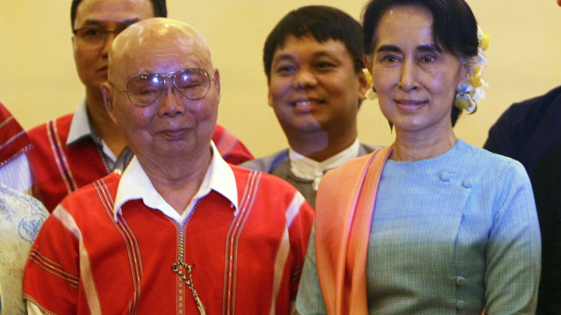 FILE - In this Aug. 24, 2016, file photo, then Myanmar's Foreign Minister Aung San Suu Kyi, right, and Mutu Say Po, chairman of Karen National Union (KNU) pose for photos during their meeting at a hotel in Naypyitaw, Myanmar days before a peace conference that seeks to end decades of armed conflict with ethnic minority groups. The future of the Myanmarâ€™s already-fragile peace process between the military, ethnic armed groups and militias is in question as the military regains control of the country after Feb. 1, 2021 coup. (AP Photo/Aung Shine Oo, File)