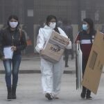 Officials carry ballot boxes at a polling station during presidential elections in Quito, Ecuador, Sunday, Feb. 7, 2021. (AP Photo/Dolores Ochoa)