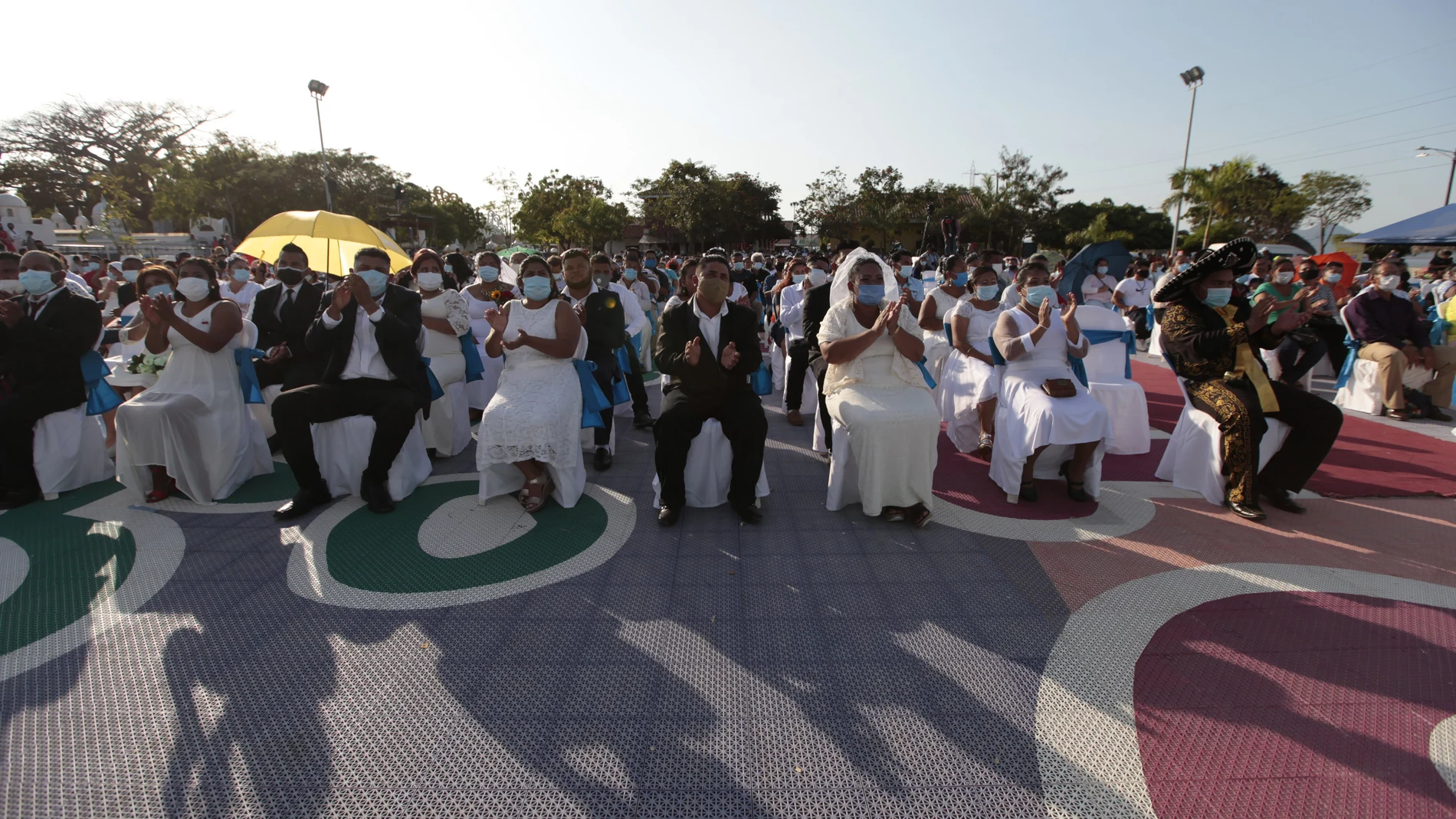 Couples sit together during a mass wedding in Managua, Nicaragua, Sunday, Feb 14, 2021. Around 400 couples said "I do" on Valentine's Day during the mass wedding. (AP Photo/Diana Ulloa)